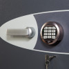 Close up of electronic lock keypad and handle on phoenix cosmos hs9074 security safe showing keys in lock