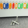 phoenix cygnus key deposit safe electronic lock showing silver floor fixing bolts on grey surface below coloured key tags