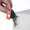 Hand holding a key with a red tag inserting it into the key deposit slot of the phoenix cygnus key deposit safe electronic lock