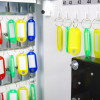 Inside door of phoenix electronic key safe showing rows of labelled colourful key tags hanging on hooks