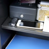 Inside the phoenix vela security safe deposit slot electronic lock showing keys, phone and other items on the shelf