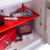 Inside the phoenix fortress 1182 security safe electronic lock showing valuables including a watch passport and money