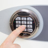 Close-up of a finger pressing the keypad on the phoenix fortress 1185 security safe electronic lock