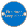 Front view of a fire door keep clear metal sign with blue background and white text reading Fire door keep clear