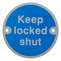 Front of a round keep locked shut metal sign with blue background and white text and two mounting holes