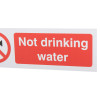 Closeup of a mandatory bathroom hygiene not drinking water sign with white text on a red background