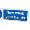 Closeup of mandatory bathroom hygiene now wash your hands sign with blue and white text