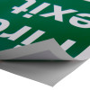 fire exit sign eec directive self adhesive down left with the corner peeled back showing the adhesive side
