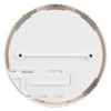 The underside of a white circular smoke alarm base showing multiple slots, screw holes, and structural ridges for ceiling installation.