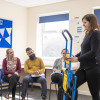 Instructor demonstrating an evacuation chair during an evacuation chair operator training session with seated participants watching