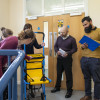 People practising with an evacuation chair during evacuation chair operator training practical session
