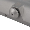 Closeup of the adjuster on a rutland overhead door closer silver showing the screw and surrounding metal parts