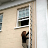 Saffold Fold Out Fire Escape Ladder Child installed outside a window with a person climbing down the ladder
