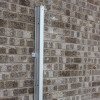 Saffold Fold Out Fire Escape Ladder in closed position mounted against a brick wall