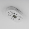 Carbon monoxide alarm mounted on ceiling using magnetic alarm mounting kit shown in situ