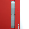 Close-up of a metal part on the frame of a tempus temporary fire door showing screws and fittings