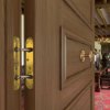 Close-up of part of the perko powermatic heritage door installed with brass fittings in a traditional interior