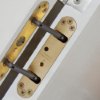perko powermatic close-up of an indoor door handle and locking mechanism on a white door