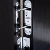 perko powermatic r100 close-up of metal latch fitted to dark coloured door shown indoors