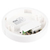The internal components of a circular smoke alarm base, including a circuit board, relay, and printed specification label.