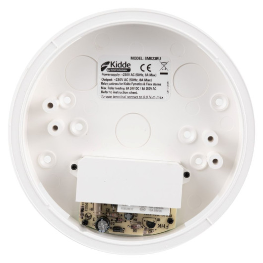 The underside of a Kidde SMK23RU relay pattress showing mounting holes, internal circuitry, and a printed specification label.