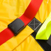 spectrum healthcare resqmat showing a close-up of a black plastic buckle attached to a red strap on a yellow fabric background