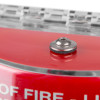 Close-up detail of the red sti flush mounted call point cover showing metal fixing and part of the label text