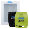 A bright green ZOLL AED Plus defibrillator and its black carrying case positioned in front of a white wall‑mounted CARDIACT cabinet used for storing emergency AED equipment.