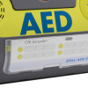 Closeup of the zoll aed 3 defibrillator wall mounted bracket showing part of the device and label