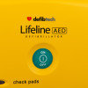 defibtech lifeline semi automatic defibrillator closeup of green on off button on yellow background