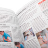 Close up of an open st john ambulance first aid manual showing text and photos of first aid instructions on choking