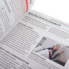 Close up of pages from st john ambulance first aid manual showing text and an image of two people in a room