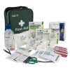 Part of the st john universal plus kit showing the first aid contents including bandages scissors wipes and ice pack