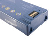 Close-up of a blue Philips device called heartstart showing a section with electrical contacts and warning symbols