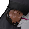 Close up of the face of laerdal little anne training manikin with bag dark skin lying on a dark surface