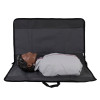 Laerdal Little Anne training manikin with dark skin tone lying inside an open black carry bag