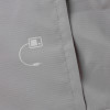 Close up of the jacket on the laerdal little anne training manikin with bag light skin showing fabric texture and a small printed white symbol