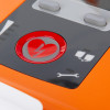 Closeup of red button with heart and lightning symbol on cardiac science powerheart g5 semi automatic defibrillator