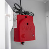 Closeup of the red alarm unit inside a zoll aed plus wall mount cabinet showing its details and wiring