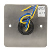 Back view of an access control green dome exit button showing the metal plate and connected blue and yellow wires