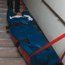 patient being evacuated down the stairs in an evacuation mattress overlay