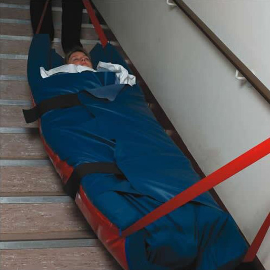 patient being evacuated down the stairs in an evacuation mattress overlay