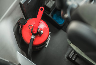 A fire extinguishers in the cab of a truck