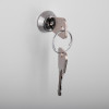 Key inserted in lock of mailsafe residential mailbox shown against plain background