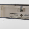Interior of the anti‑arson mailbox showing the extinguisher mechanism and safety label