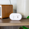 UltraFire UBCO1 Carbon Monoxide Alarm on a wooden shelf next to a wooden speaker and white vase