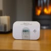 Close up of ultrafire ubco1d carbon monoxide alarm with display showing temperature reading on table