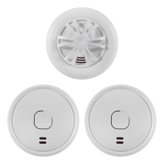 Group of three white battery smoke alarms and heat alarm home essentials kit items on a white background