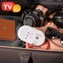 carbon monoxide alarm in a suitcase with camera, sunglasses and passport