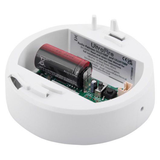 angled view of ultrafire radio interlinked 10yr battery heat alarm base showing battery and internal components